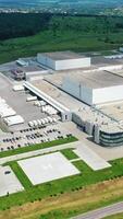 Contemporary industrial complex. Huge territory of production plant on nature background. View from the air. Motion camera top down. Vertical video