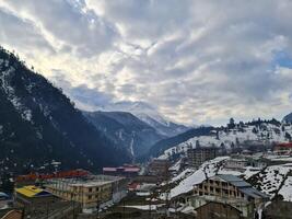 A view of a snowy mountain town with buildings and snow photo