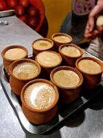 A tray of cups of coffee sitting on a table photo
