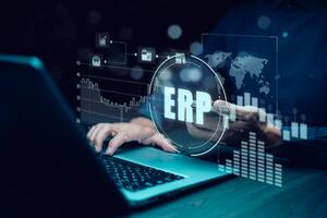 Business people using a laptop with document management for ERP. Enterprise resource planning concept,Enterprise Resource Management ERP software system for business resources plan presented. photo