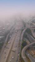 Complexity of the highways in modern San Francisco. Urban panorama covered with thick white fog. Vertical video