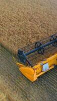 Combine harvester working on a wheat field. Combine harvester Aerial view. Vertical video
