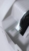 Rotating mechanism turning quickly money in the currency counter machine. One hundred dollars in the slot of apparatus. Close up. Top view. Vertical video