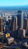 Gorgeous skyscrapers surrounded by busy traffic roads in Los Angeles, USA. Beautiful high buildings at the backdrop of endless cityscape. Vertical video