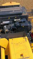 Combine harvester in action on the field. Combine harvester. Harvesting machine for harvesting a wheat field. Vertical video