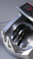 Compact electronic money counting equipment. A pack of hundred dollars counted quickly in the cash machine. Close up. Vertical video