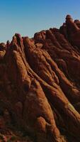 Magnificent rock formations from air erosion. Unusually shaped flat canyons at backdrop of blue skies. Vertical video