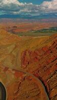 Rocky scenery of amazing canyons in Utah, USA. Motorway leading to the green valley. Stunning cloudscape at backdrop. Vertical video