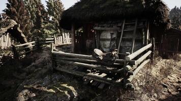Weathered motorcycle resting on a wooden fence in a rural setting video