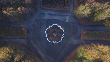 Beautiful quiet park. Clip. Drone view of a small park with walking roads and a fountain. video