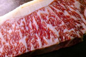 close up of a piece of raw beef.Fresh Wagyu steak with visible meat marbling photo