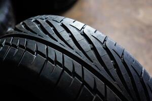 Closeup racing pattern tires.New tires in the garage with customer serviceCar tire close up. Tyre background. Car tire background. photo