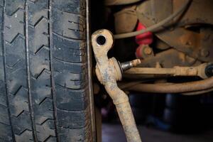 Old car ball joints, suspension background.The mechanic is repairing the truck suspension. photo
