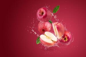 Water splashing on Fresh Red apple on a red background photo