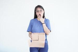 beautiful Asian woman holds a box package, displaying a shocked wow face expression against a white background photo