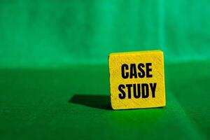 Case study message written on yellow wooden cube with green background. Conceptual case study symbol. Copy space. photo