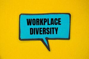 Workplace diversity message written on blue paper speech bubble with blue background. Conceptual workplace diversity symbol. Copy space. photo