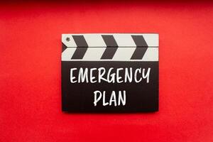 Emergency plan message written on clapperboard with red background. Conceptual emergency plan symbol. Copy space. photo