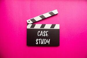 Case study message written on clapperboard with pink background. Conceptual case study symbol. Copy space. photo