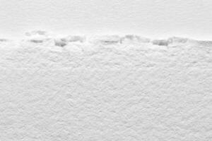 Torn edge textured white paper background with subtle fiber details for creative design projects. photo