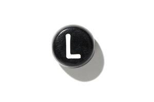 Black keyboard key with white letter l on white background. minimalist technology design photo