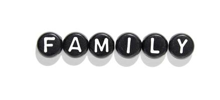 Minimalist black and white typography of the word family on circular beads on white background photo