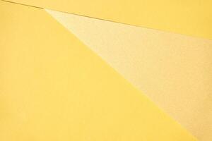Abstract composition with overlapping yellow textured paper layers creating geometric shapes in minimalistic design. photo