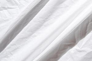 Abstract white wrinkled fabric texture with soft light and subtle shadows for minimalist design backgrounds. photo