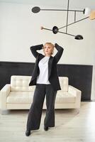 Modern interior design with minimalist mobile art and elegant woman in contemporary living space. photo