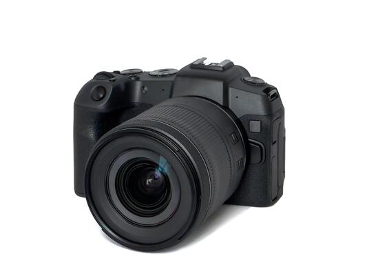 Photo camera body with zoom lens isolated on white background