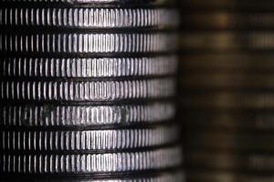 Stack of coins in close-up, texture of old coins, silver and bronze photo