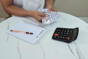 Man's Hands with Dollar for shopping list photo