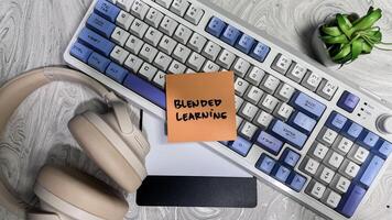Concept of Blended Learning write on sticky notes isolated on Wooden Table. photo