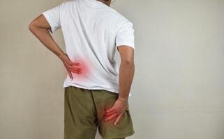 Man feeling nerve pain from lower back and goes down to legs. Sciatica concept photo