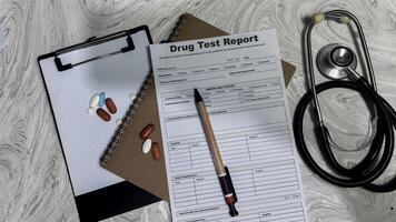 Concept of Drug Test Report write on document isolated on Wooden Table. photo