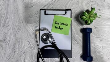 Concept of Glycemic Index write on sticky notes isolated on Wooden Table. photo