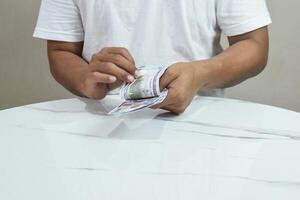 Person's hands holding and counting money in cash photo