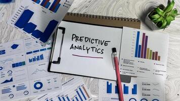 Concept of Predictive Analytics write on paperwork isolated on wooden background. photo