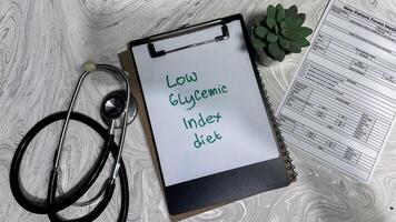 Concept of Low Glycemic Index Diet write on paperwork isolated on wooden background. photo