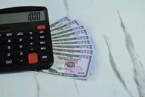 fifty dollar and calculator on the table, financial management concept photo