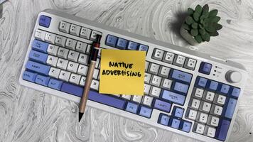 Concept of Native Advertising write on sticky notes isolated on Wooden Table. photo