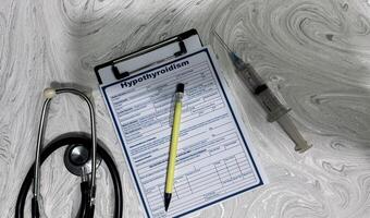 Concept of Hypothyroidism write on document isolated on Wooden Table. photo