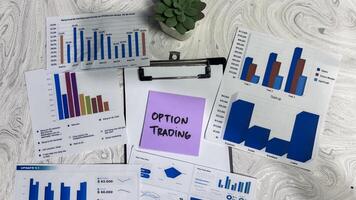 Concept of Option Trading write on sticky notes isolated on Wooden Table. photo