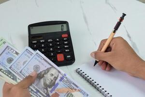 A man is counting Dollar banknotes, financial management concept photo