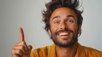 Extremely happy man looking up and pointing with finger photo