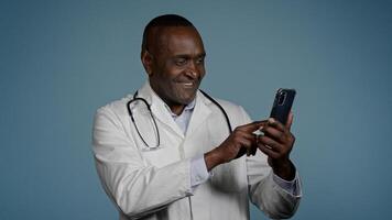 African American man doctor physician using medical virtual mobile application on phone remote browsing analysis results chat with patient on smartphone distance consultation medicine and modern tech photo