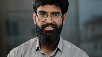 Young guy hispanic handsome bearded man smiling looking at camera male portrait brunette indian businessman assistant manager entrepreneur posing confident facial optimistic reaction standing indoors photo