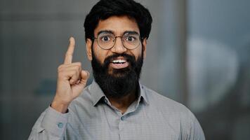 Pensive adult bearded man arabian puzzled businessman deep in thoughts memory concentrate thinking solution of business issue get inspiration creating startup coming up with idea raised index finger photo