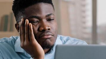Bored disappointed african man american male businessman have sleeping problem lazy young exhausted guy slumber rest at home workplace feel passive emotion tired from monotone online work at computer photo