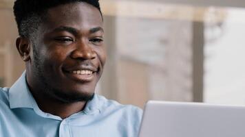 Thoughtful african american businessman writer dreamer genius man biracial guy holds hand on chin creates business plan come up with idea for startup uses computer typing text creates internet project photo